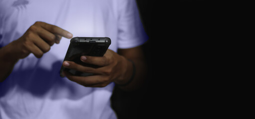 Close up of a man using mobile smart phone and copy space