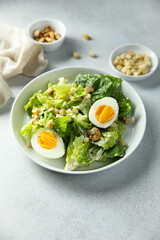 Healthy green salad with cashew and hard boiled eggs	