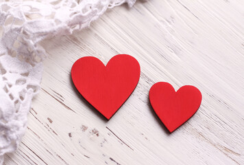 Two red hearts on a white wooden background. Valentine's Day