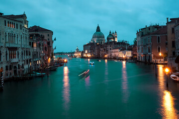 Naklejka na ściany i meble Late evening canals with boats, lanterns and motion blurs in dark. Venice.