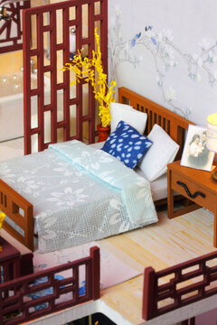 Chinese-style Bedroom Interior In Miniature Dollhouse . Toy Bed With Bed Linen And Pillows