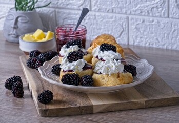 Fresh scones topped with Blackberry jam,whipped cream and fresh fruit