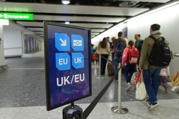 View of a Generic UK/EU Lane Sign as Air Travellers Proceed to Passport Control at a British Airport 