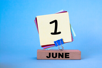 June 1st. Image of June 1 wooden color calendar on blue background. First summer day. Happy Children's Day