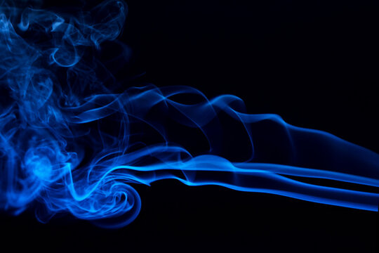 Abstract colored smoke hookah on dark background. Texture. Art Design element. Personal vaporizers fragrant steam. Concept of alternative non-nicotine smoking. E-cigarette. Blurry image, soft focus