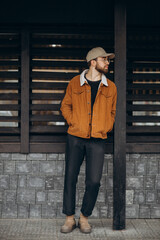 Handsome man in winter jacket posing in the street