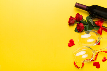 Valentine's day composition with red wine, rose flower and gift box on table. Top view, flat lay. Holiday concept