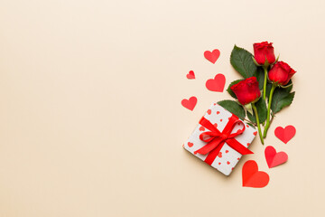 Valentine's day composition with rose flower, red heart and gift boxes on table. mother day and birthday greeting, copy space, top view