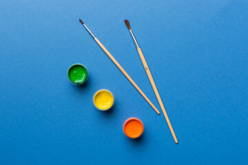 art palette with paint and brushes, close up. Top view with empty space. workplace for creativity....