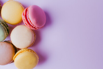 Macarons dessert on pastel tones background. Copy space.