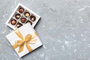 White box with chocolates candies and golden tape. top view with copy space