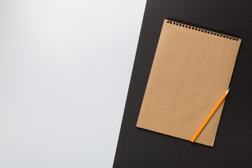 school brown notebook on a colored background, spiral craft notepad on a table Top view