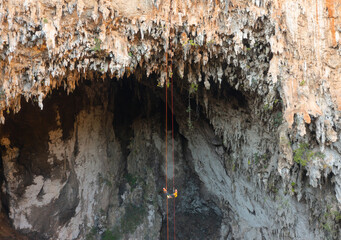 Aerial top view of tourist sprinkle the rope at Spirit Well Cave, Pang Mapha District, Mae Hong Son, Thailand. Adventure activity lifestyle. People. Tourist attraction landmark. Nature landscape.