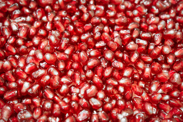 Close-up of fresh and ripe pomegranate seeds. Texture of pomegranate seebs as background.