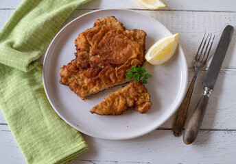 Vienna schnitzel isolated on a plate with lemon