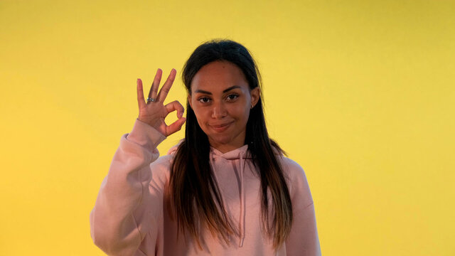 Happy African Girl Showing Okay Hand Gesture And Thumps Up