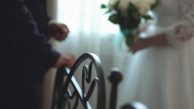 the bride and groom hold hands
