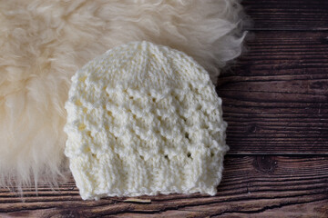 lovely hand knit baby hat in neutral white colour for a gift idea 