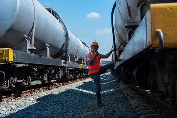 Naklejka premium engineer inspection and checking oil tank for transportation on rail system. 