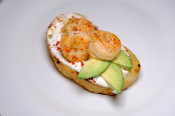 Avocado sandwiches, with seasame and shrimps on a white background close up macro