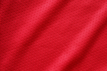 Fototapeta na wymiar Red sports clothing fabric football shirt jersey texture close up