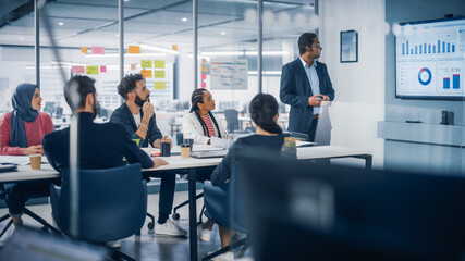 Modern Multi-Ethnic Office Conference Room Meeting: Diverse Team of Young Entrepreneurs, Specialists Talk, Use TV for infographics. Businesspeople Discuss Investment Strategy for e-Commerce Startup