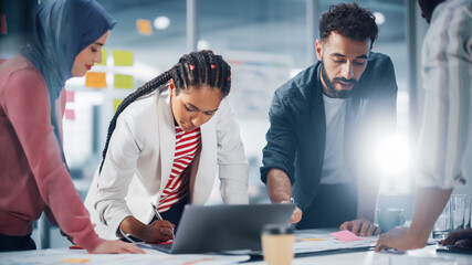 Multi-Ethnic Office Conference Room Businesspeople Meeting at Big Table. Diverse Team of Creative Entrepreneurs Talk, Find Solution. Specialists work in Digital e-Commerce Startup.