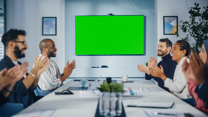 Modern Multi-Ethnic Office Conference Room Meeting: Diverse Team of Successful Managers, Executives Use Green Screen Chroma Key TV, Celebrate and Applaud Successful e-Commerce Product Release