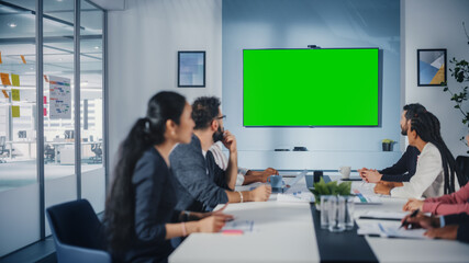 Multi-Ethnic Office Conference Room Meeting: Diverse Team of Successful Managers, Executives Talk, Use Green Screen Chroma Key TV. Businesspeople Investing in eCommerce Startup. - obrazy, fototapety, plakaty