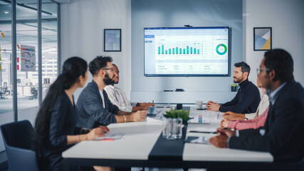 Multi-Ethnic Office Conference Room Meeting: Diverse Team of Managers, Executives Talk, Uses Wall...