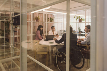 Latin mixed people meeting in business ecology office with glass walls