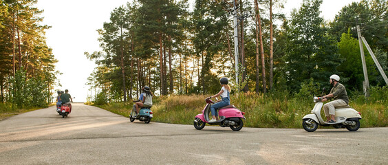Young multiracial company riding scooter motorbikes © Svitlana
