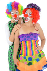 Funny clowns with red nose, costume and wig are laughing