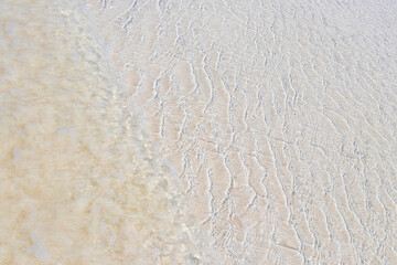 Texture of clear sandbank water Holbox island beach in Mexico.
