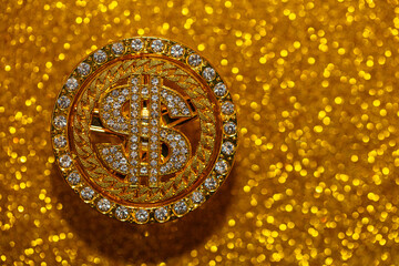 golden dollar sign with gemstones on yellow glitter background