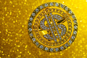 golden dollar sign with gemstones on yellow glitter background