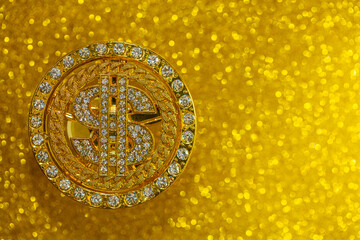 golden dollar sign with gemstones on yellow glitter background