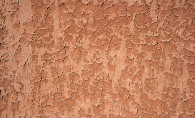 Rough background. Detail of a plastered wall. Trend color 2022 Calming Coral.