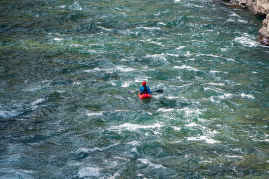 River Kayaker In Red Kayak Are Paddling Whitewatered River, Overhead Shot. Extreme Sports And Adrenaline Concept.