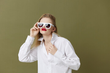 blonde woman in white shirt sunglasses isolated background
