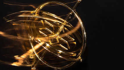 Golden Gyroscope Spinning Wildly on its Base