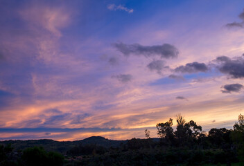 Multiple exposure composite of colorful soft clouds at west at sunrise, in the eastern Andes range in central Colombia near the colonial town of Villa de Leyva.