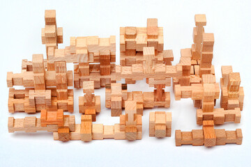 Pieces of a wooden construction set on white table
