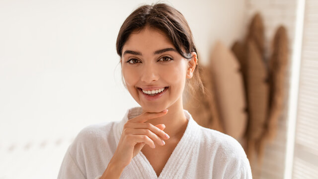 Happy Woman Posing Smiling To Camera Touching Face In Bathroom