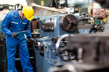 Mechanical Engineering control lathe machine in factory facility. Safety First at work place.