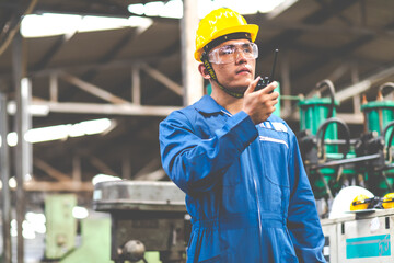 Portrait of factory worker and engineer at industrial facility. Construction worker in hardhat and...