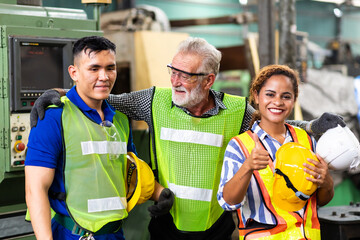 Man and Woman engineering wearing safety goggles and hard hats giving high five and celebrating...