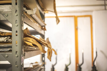 Printing house warehouse and metal shelf with paper. Working process, printing indutry concept