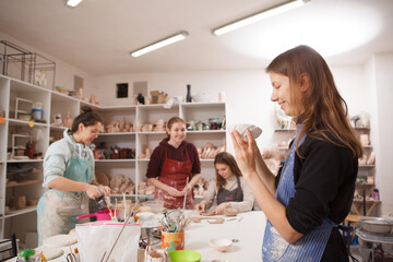 Female potters working at art studio