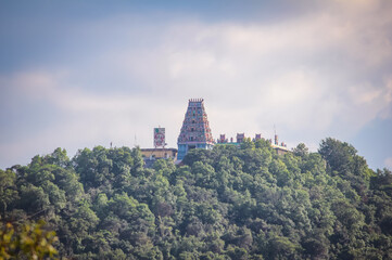Beautiful view of the temple tower of an Hindu god over an hilltop. English Translation: Om